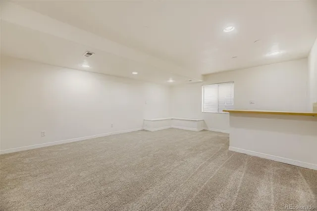 an empty room with a empty space and windows