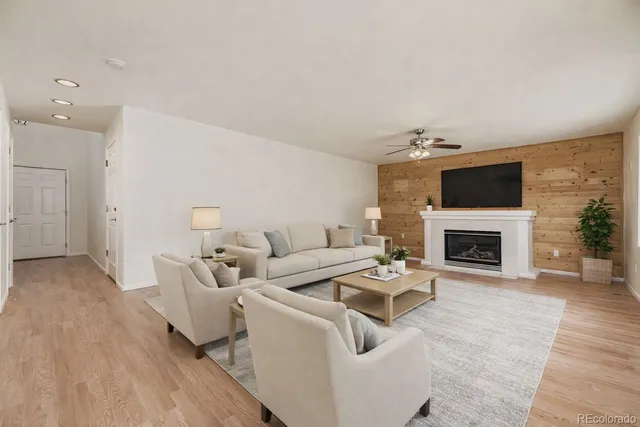 a living room with furniture a fireplace and a flat screen tv