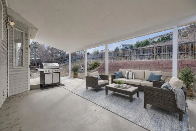 a living room with furniture and a floor to ceiling window