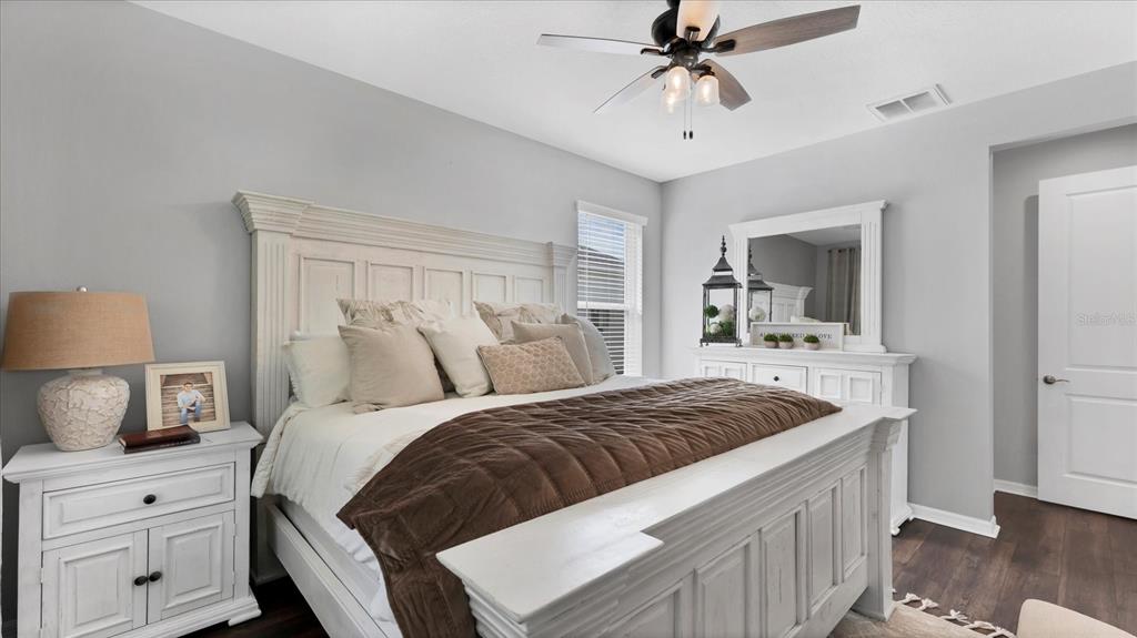 5935 Maidenstone Way Palmetto, FL 34221 - Photo 11 of 52 a bedroom with a bed and a chandelier