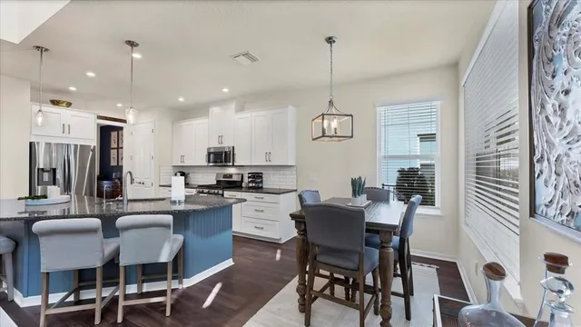 a large kitchen with a table and chairs