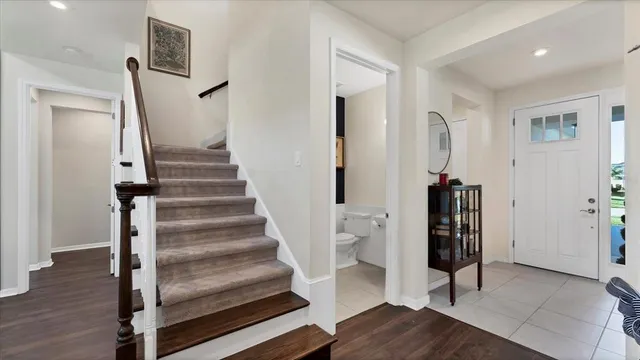a view of entryway with wooden floor and stairs
