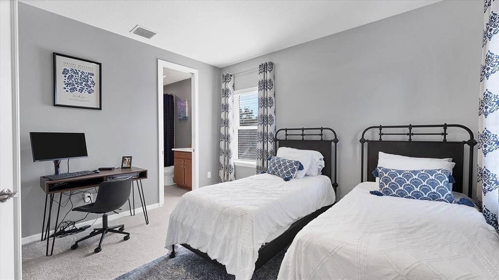 5935 Maidenstone Way Palmetto, FL 34221 - Photo 23 of 52 a bedroom with two beds and a desk