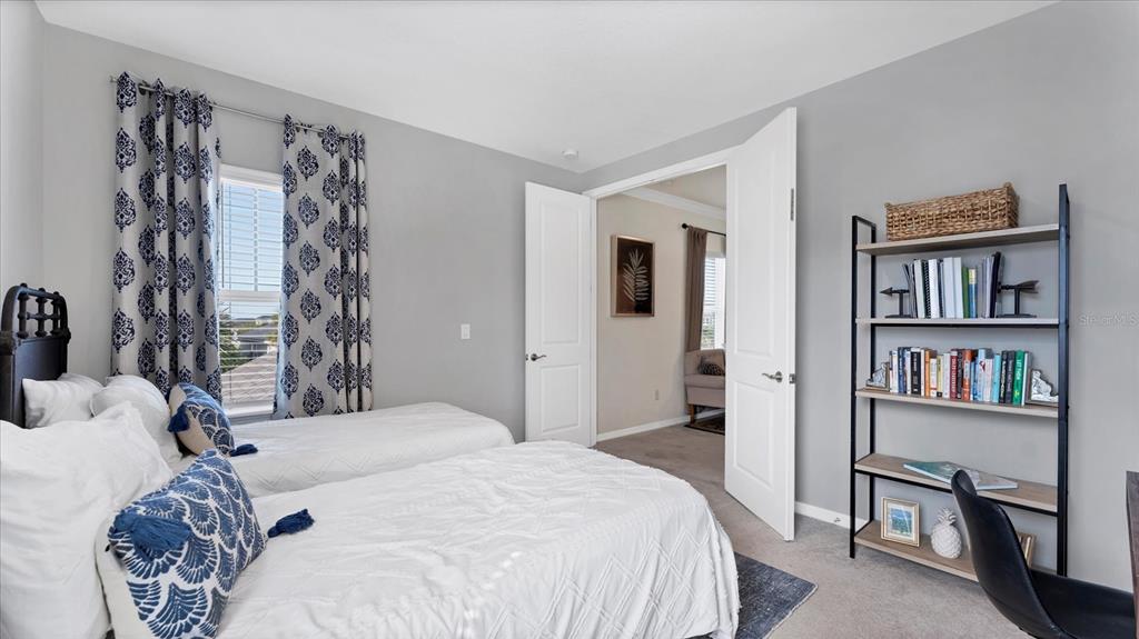 5935 Maidenstone Way Palmetto, FL 34221 - Photo 24 of 52 a bedroom with a large bed and a book shelf