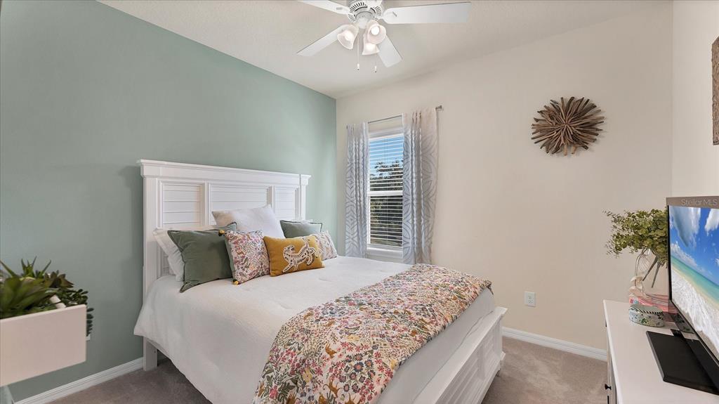 5935 Maidenstone Way Palmetto, FL 34221 - Photo 31 of 52 a bedroom with a bed and a chandelier