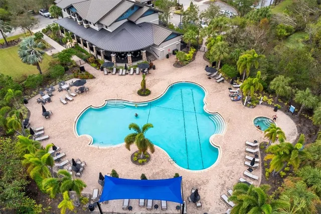 an aerial view of a house with a yard and lake view