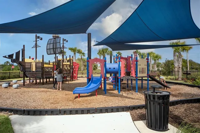 an aerial view of a swimming pool with lawn chairs