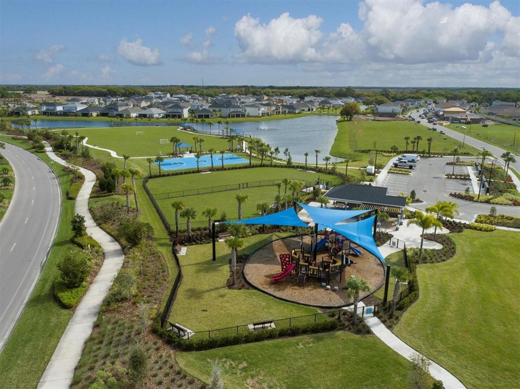 5935 Maidenstone Way Palmetto, FL 34221 - Photo 46 of 52 an aerial view of a swimming pool with lawn chairs