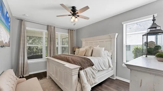 a bedroom with a large bed and a large window