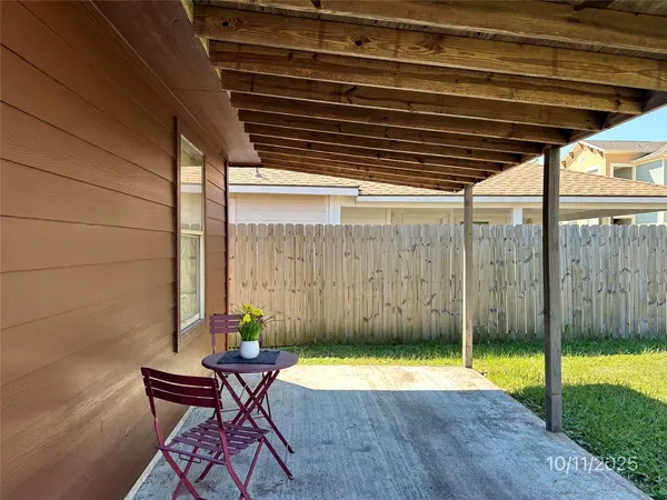 a view of swimming pool with chair and table in the patio