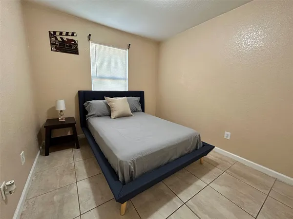 a bedroom with a bed and cabinets