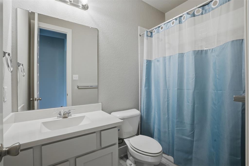 1429 Eclipse Road Aubrey, TX 76227 - Photo 21 of 37 Bathroom featuring a vanity with an integrated sink, a mirror, and a toilet