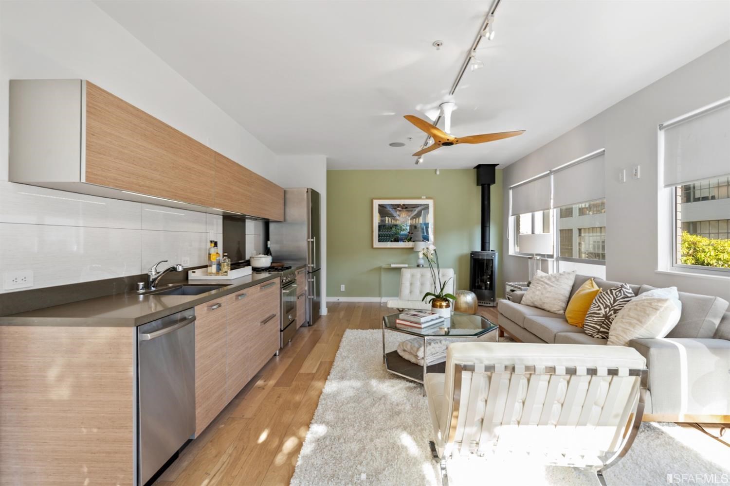 788 Minna, Unit 202 San Francisco, CA 94103 - Photo 2 of 11 a living room with stainless steel appliances furniture a rug and a kitchen view