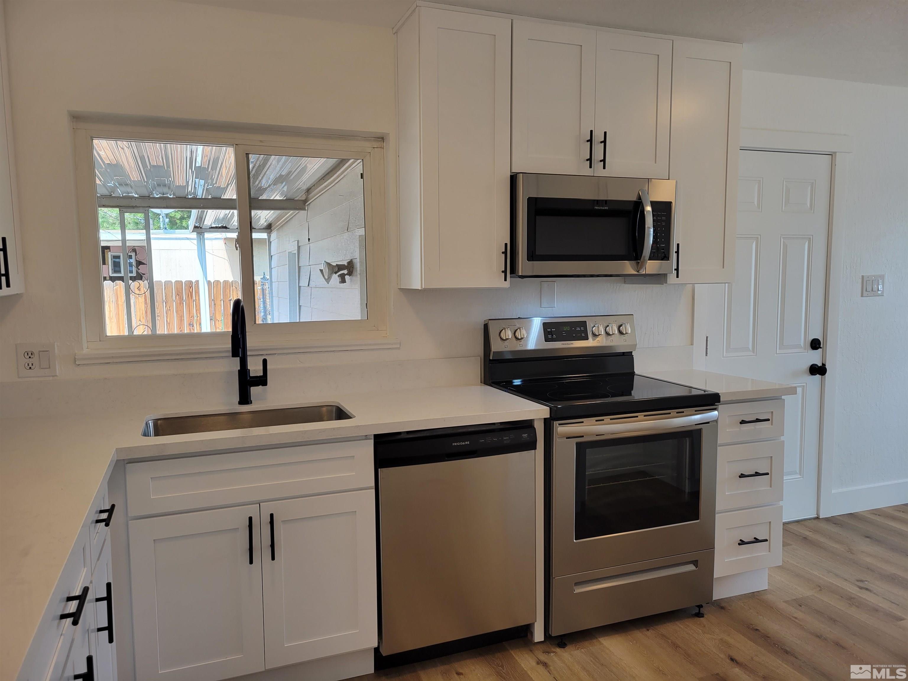 1801 Radcliffe Drive Reno, NV 89502 - Photo 2 of 18 a kitchen with white cabinets and a stove top oven