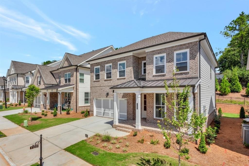 1130 Pennington View Lane Alpharetta, GA 30004 - Photo 1 of 1 a front view of a house with garden
