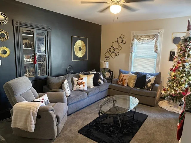 a living room with furniture and a potted plant