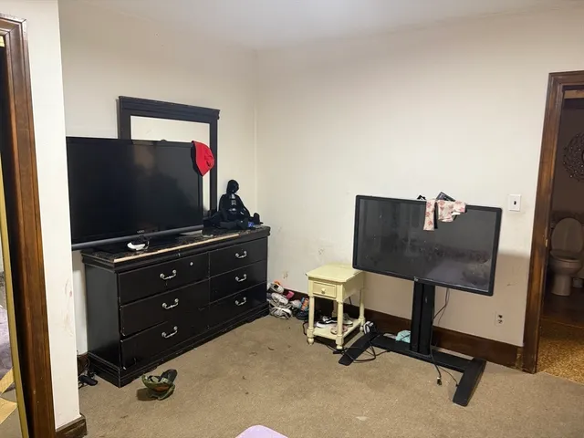 a view of a workspace with furniture and a flat screen tv