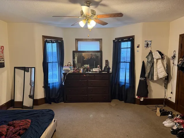 a room with a bed and a chandelier