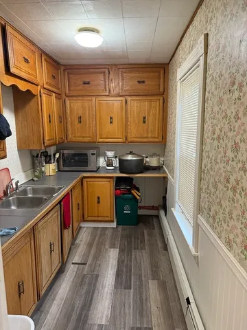 a kitchen with wooden cabinets and a sink