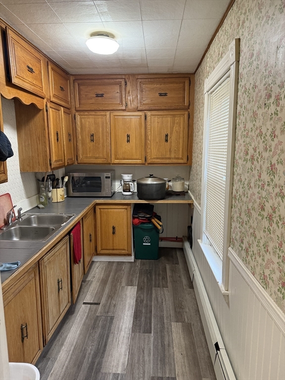 195 Millbury Street Worcester, MA 01610 - Photo 3 of 25 a kitchen with wooden cabinets and a sink