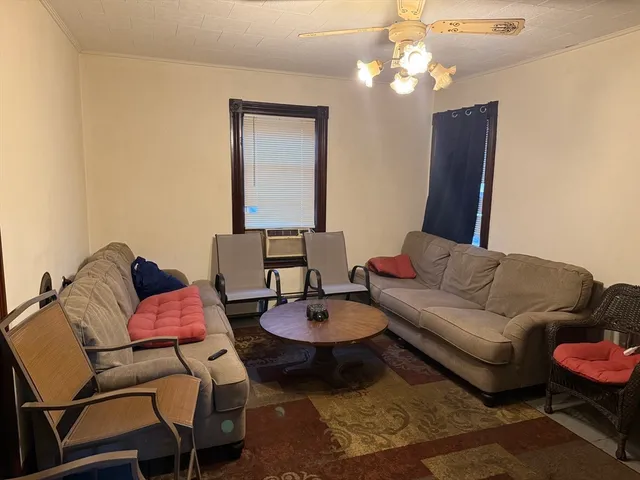 a living room with furniture and a mirror