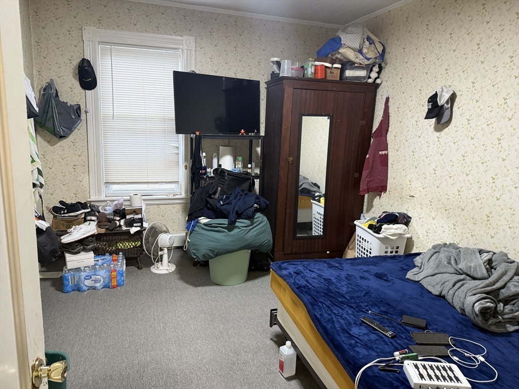 195 Millbury Street Worcester, MA 01610 - Photo 6 of 25 a living room with furniture and a flat screen tv