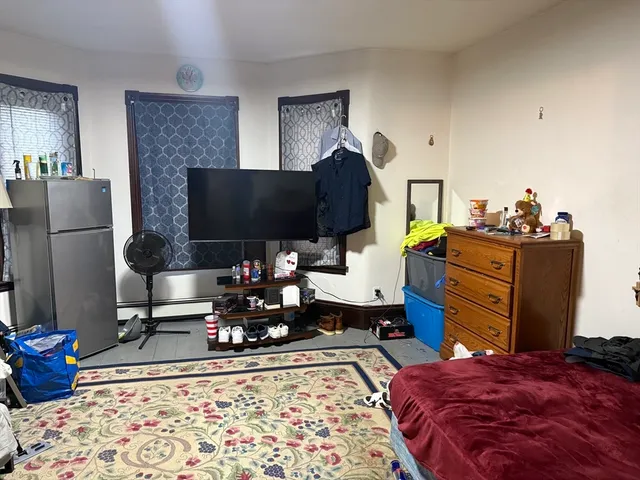 a bedroom with a bed and flat screen tv