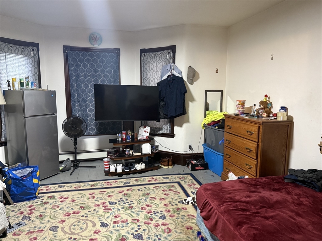 195 Millbury Street Worcester, MA 01610 - Photo 7 of 25 a bedroom with a bed and flat screen tv