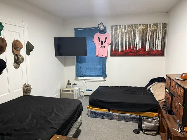 a bedroom with a bed and dresser