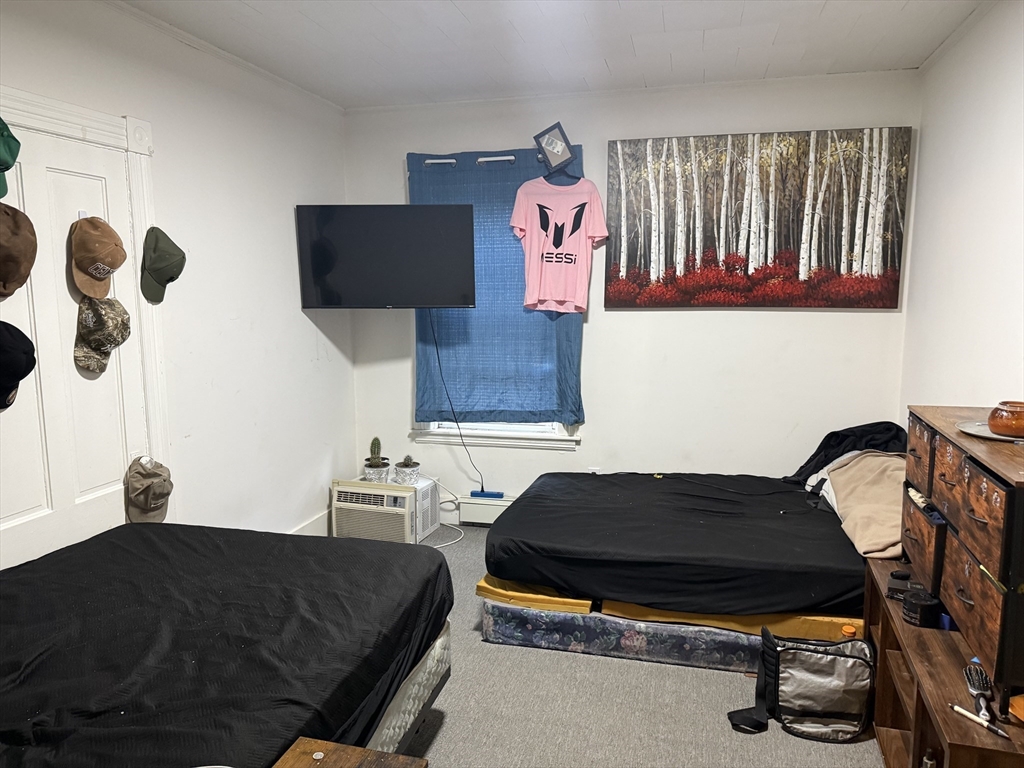 195 Millbury Street Worcester, MA 01610 - Photo 8 of 25 a bedroom with a bed and dresser