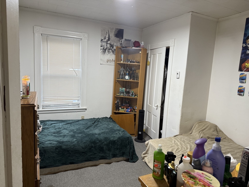 195 Millbury Street Worcester, MA 01610 - Photo 9 of 25 a bedroom with a bed and cabinets