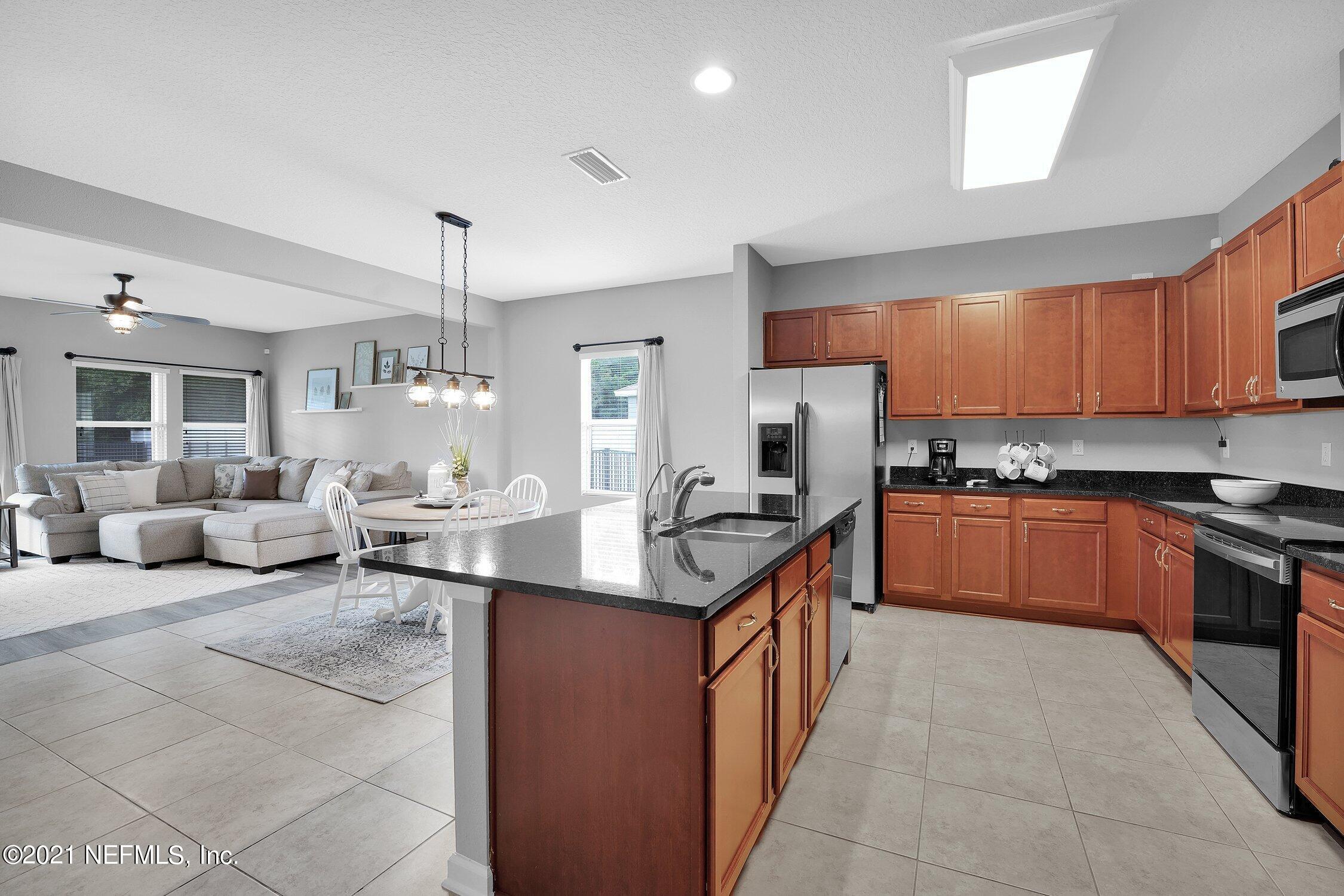 16342 Tisons Bluff Road Jacksonville, FL 32218 - Photo 11 of 57 a kitchen with stainless steel appliances granite countertop a stove a sink and a refrigerator