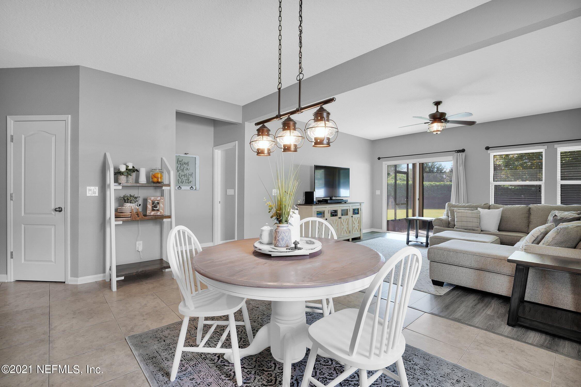 16342 Tisons Bluff Road Jacksonville, FL 32218 - Photo 12 of 57 a dining room with furniture a chandelier and window