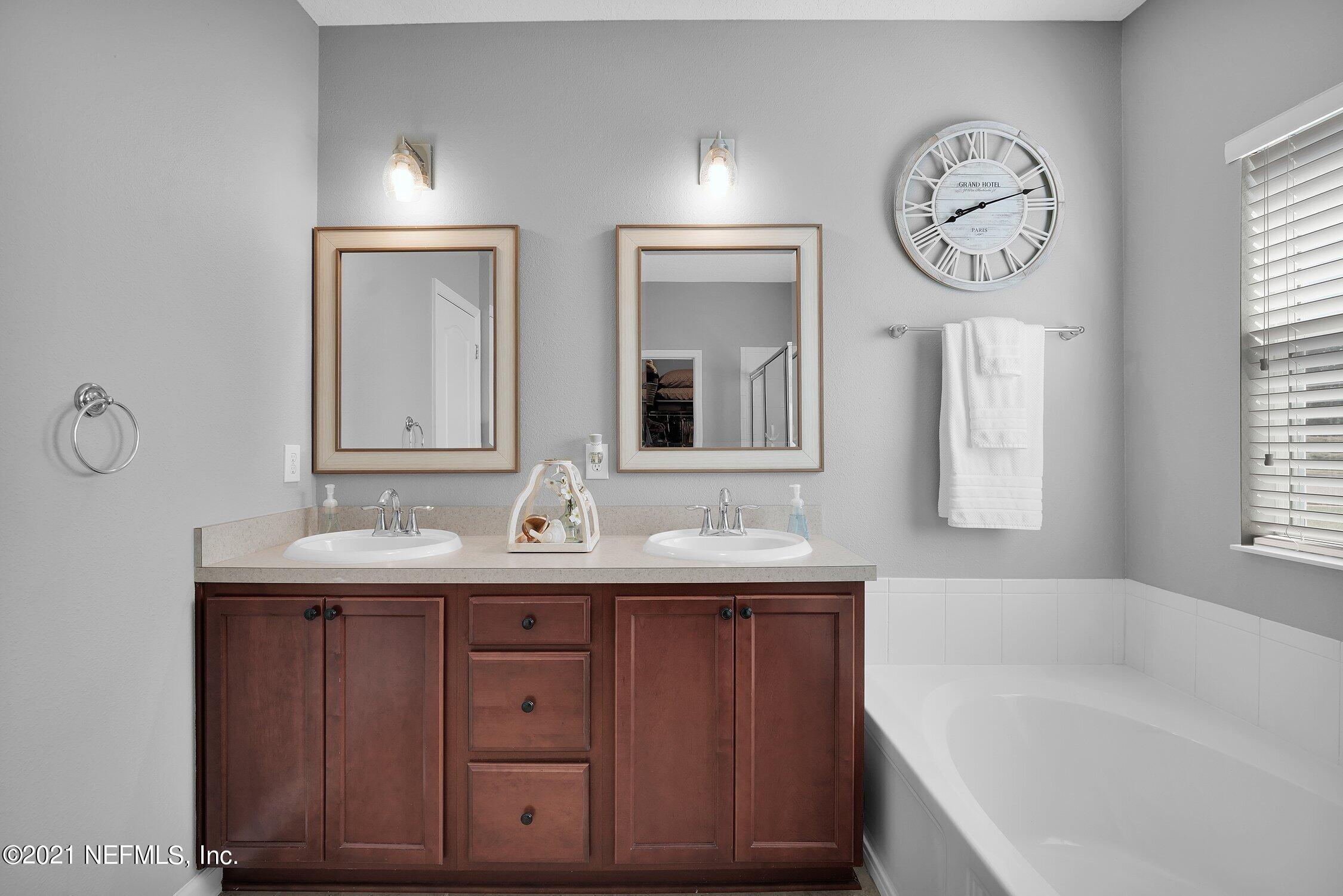 16342 Tisons Bluff Road Jacksonville, FL 32218 - Photo 18 of 57 a bathroom with a tub sink and mirror