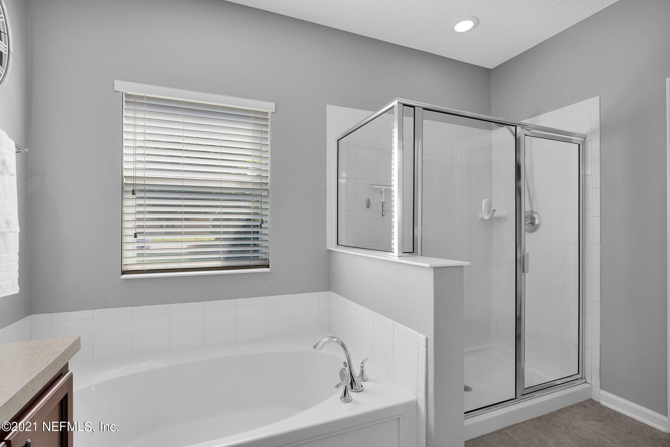 16342 Tisons Bluff Road Jacksonville, FL 32218 - Photo 19 of 57 a bathroom with a bathtub and a shower