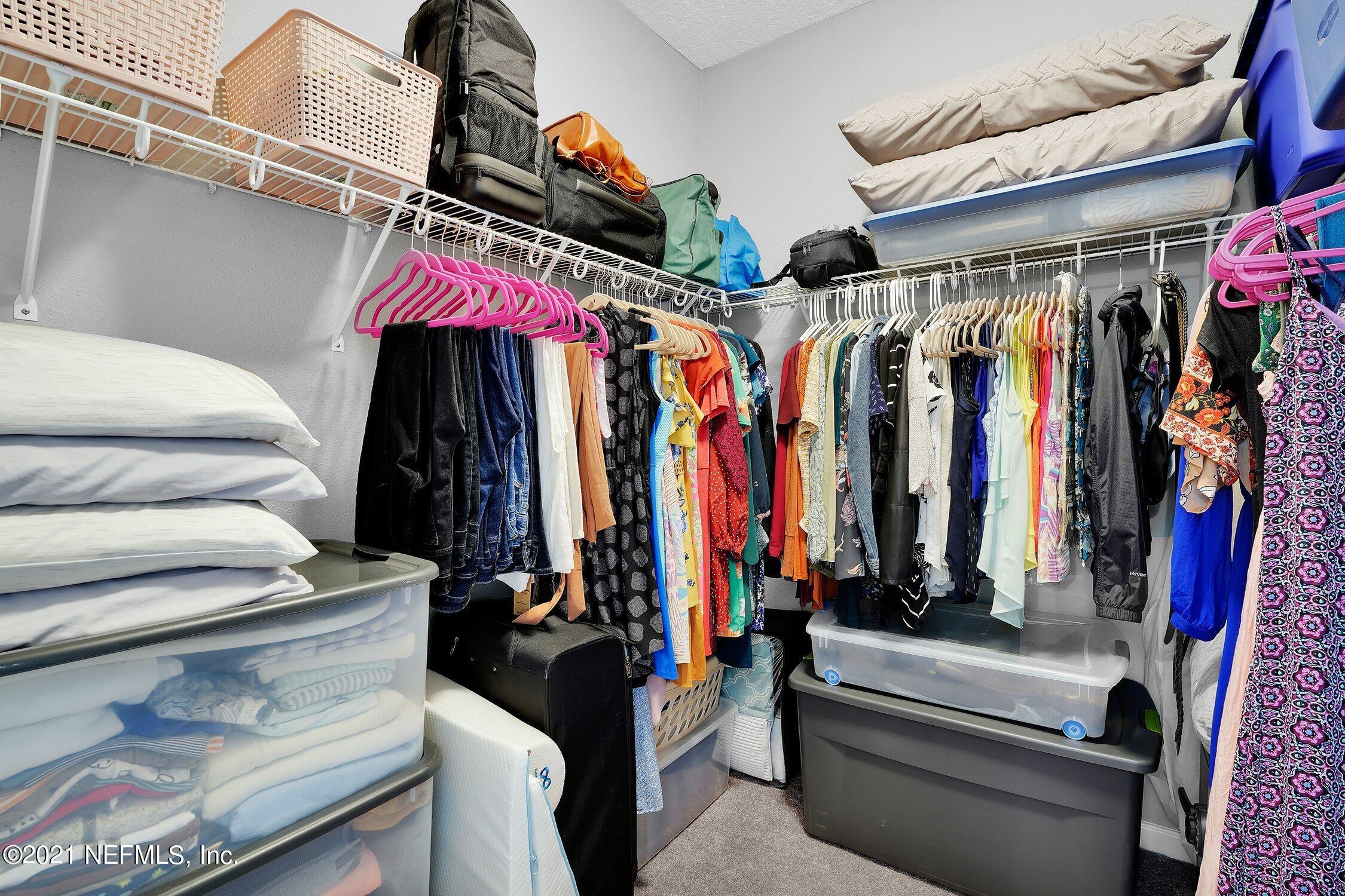 16342 Tisons Bluff Road Jacksonville, FL 32218 - Photo 20 of 57 a view of walk in closet with clothes and shoes