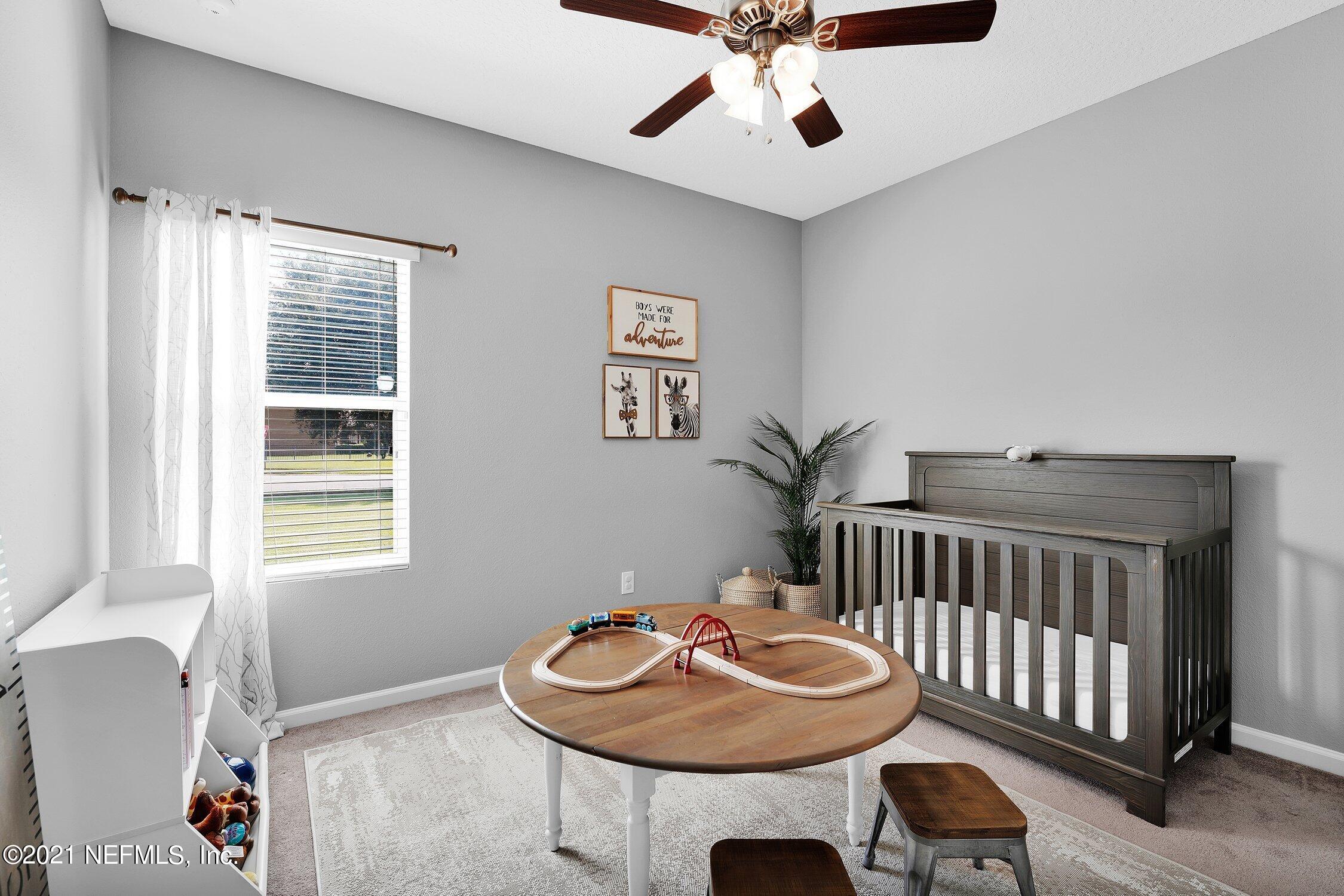 16342 Tisons Bluff Road Jacksonville, FL 32218 - Photo 22 of 57 a bedroom with furniture and a window