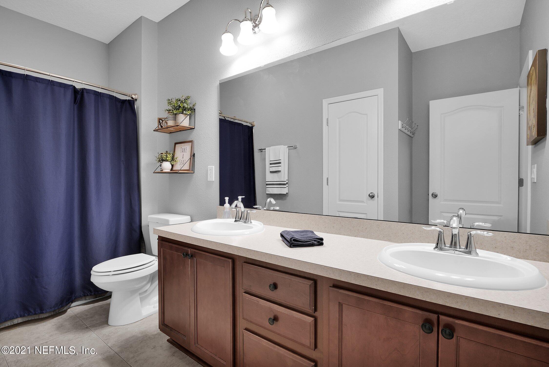 16342 Tisons Bluff Road Jacksonville, FL 32218 - Photo 23 of 57 a bathroom with a sink toilet and mirror