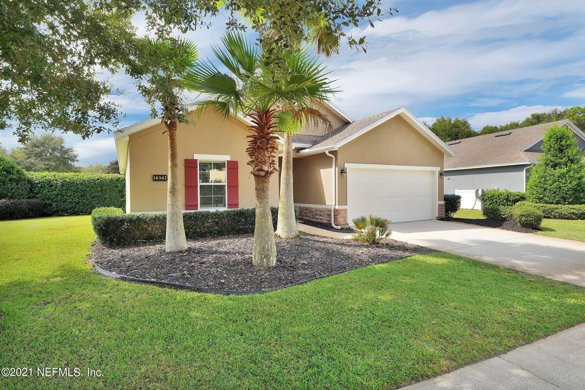 16342 Tisons Bluff Road Jacksonville, FL 32218 - Photo 5 of 57 a front view of a house with a yard garage and outdoor seating