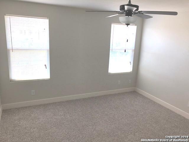 16719 Jupiter, Unit 3 Selma, TX 78154 - Photo 20 of 27 an empty room with a window and a fan