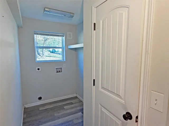 a view of an entryway with wooden floor