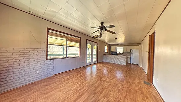 a kitchen with granite countertop a sink a counter space cabinets and stainless steel appliances