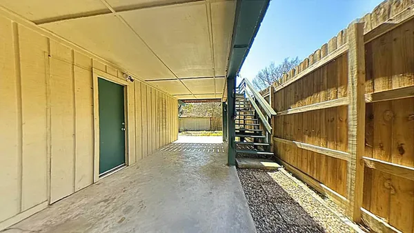 a view of balcony with wooden floor
