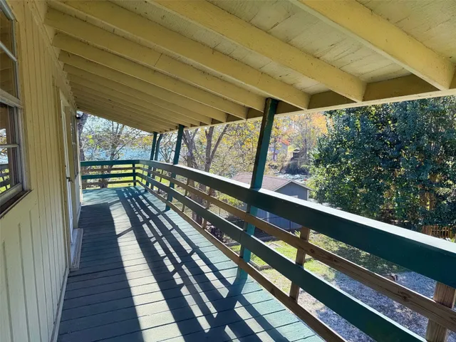 a view of two chairs in a balcony