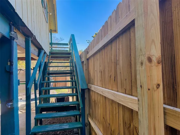 a view of two chairs in a balcony