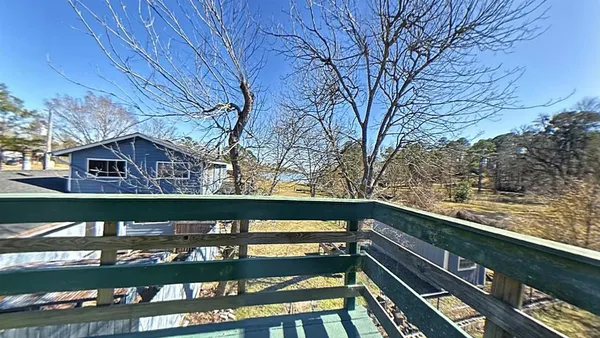 a view of an empty room and wooden floor
