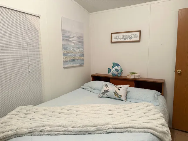 a bedroom with a bed and cupboard