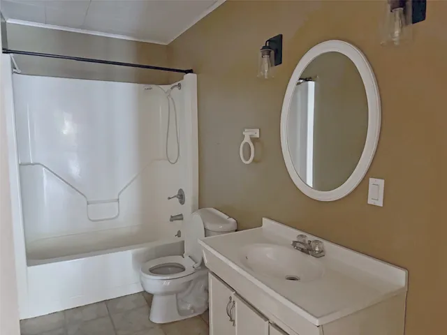 a bathroom with a sink a mirror a toilet and shower