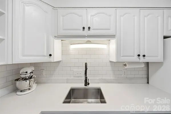 a kitchen with a sink and cabinets