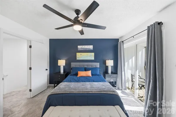 a bedroom with a large bed and a large mirror